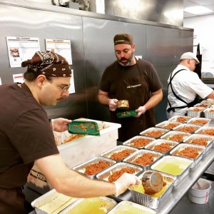 Employees of The Foodery in Boston prepare meals for delivery.