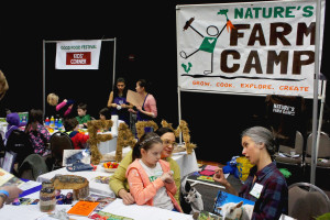 Elena Marre of Nature's Farm Camp — an overnight summer camp in the Chicago region that reconnects children with food and nature — chats with a woman and child at FamilyFarmed's Good Food Festival in Chicago March 26.