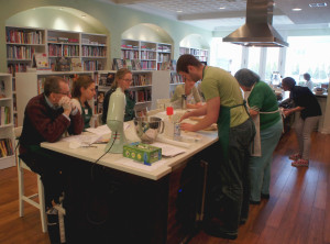 Read It & Eat, whose big windows face onto Halsted St. in Chicago's Lincoln Park community, is divided roughly in half between the book stacks and a teaching kitchen where classes, such as this doughnut-making workshop on March 12, are held. Pastry chef Kelly Dull, in the black shirt far right, taught the class.