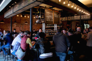 The busy bar at Forbidden Root's brewpub in Chicago. All the beers listed on the chalkboard at the city's first botanical brewery are made in-house.