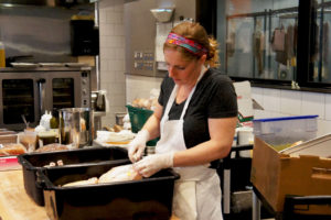 Chef Abra Berens prepares chickens at Stock — the cafe at Local Foods in Chicago. Photo: Bob Benenson/FamilyFarmed