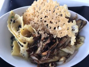 "Inn Made Burgundy Truffle Pappardelle Pasta" is served with maitake mushroom fricassee with black summer truffle butter glaze and garlic and truffle shavings with a parmigiano reggiano crisp. 